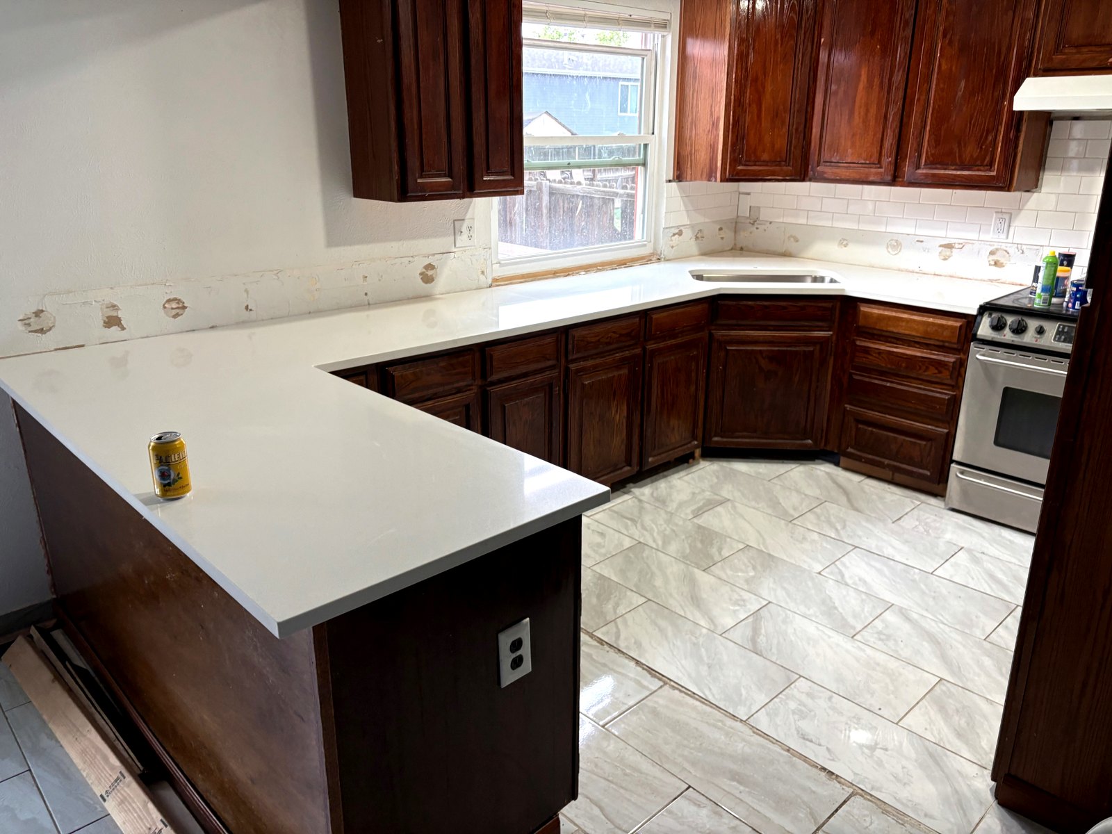 U-Shaped Kitchen Upgrade — Bright quartz surfaces paired with classic wood cabinetry